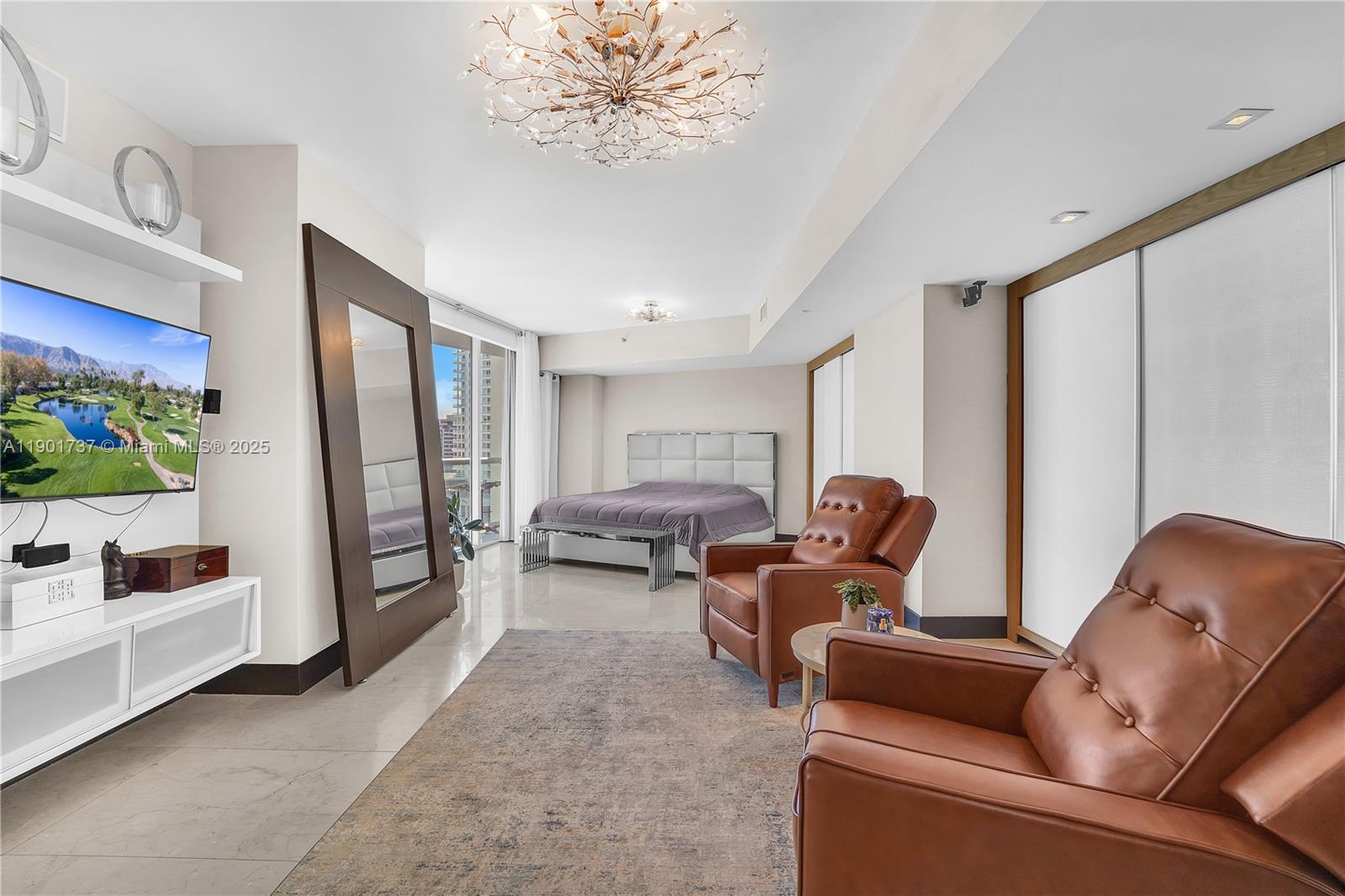 465 Brickell Avenue, Unit 1001 Miami, FL 33131 - Photo 21 of 42 a living room with furniture and a flat screen tv