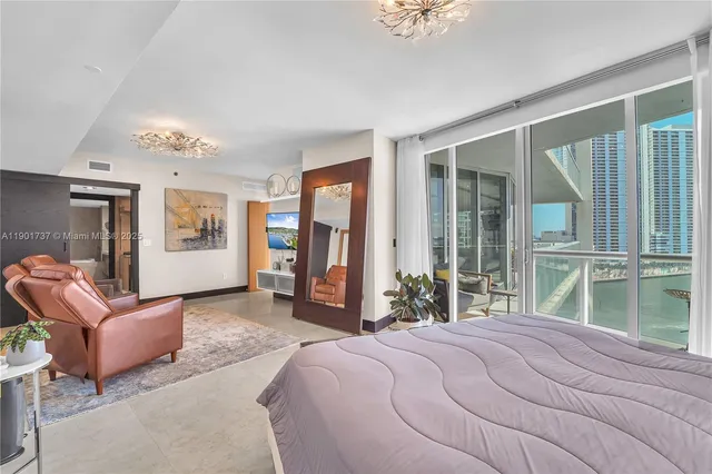 a bedroom with a large bed and a large window