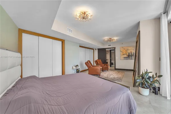 a bedroom with a bed and ceiling fan
