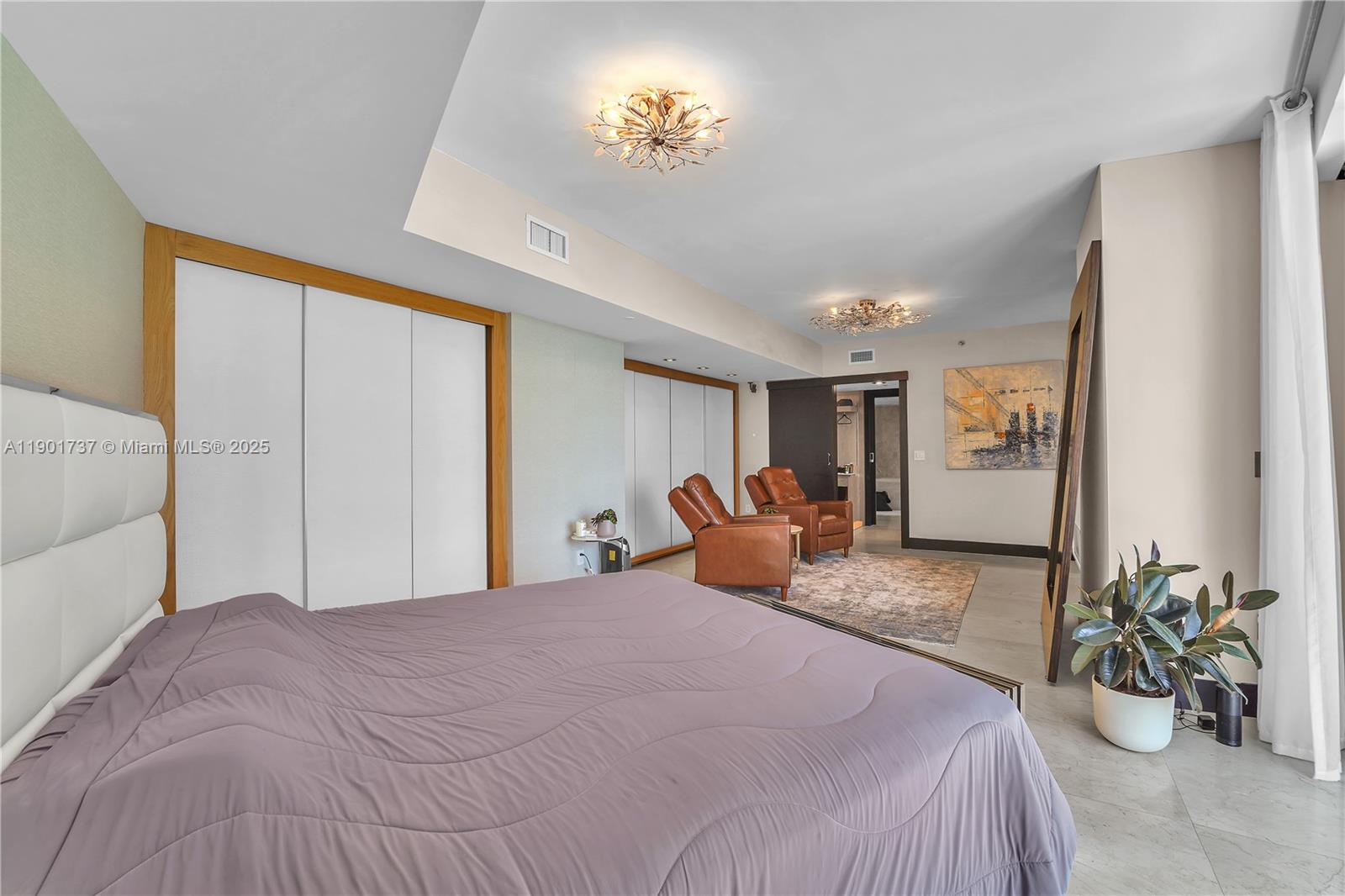 465 Brickell Avenue, Unit 1001 Miami, FL 33131 - Photo 24 of 42 a bedroom with a bed and ceiling fan