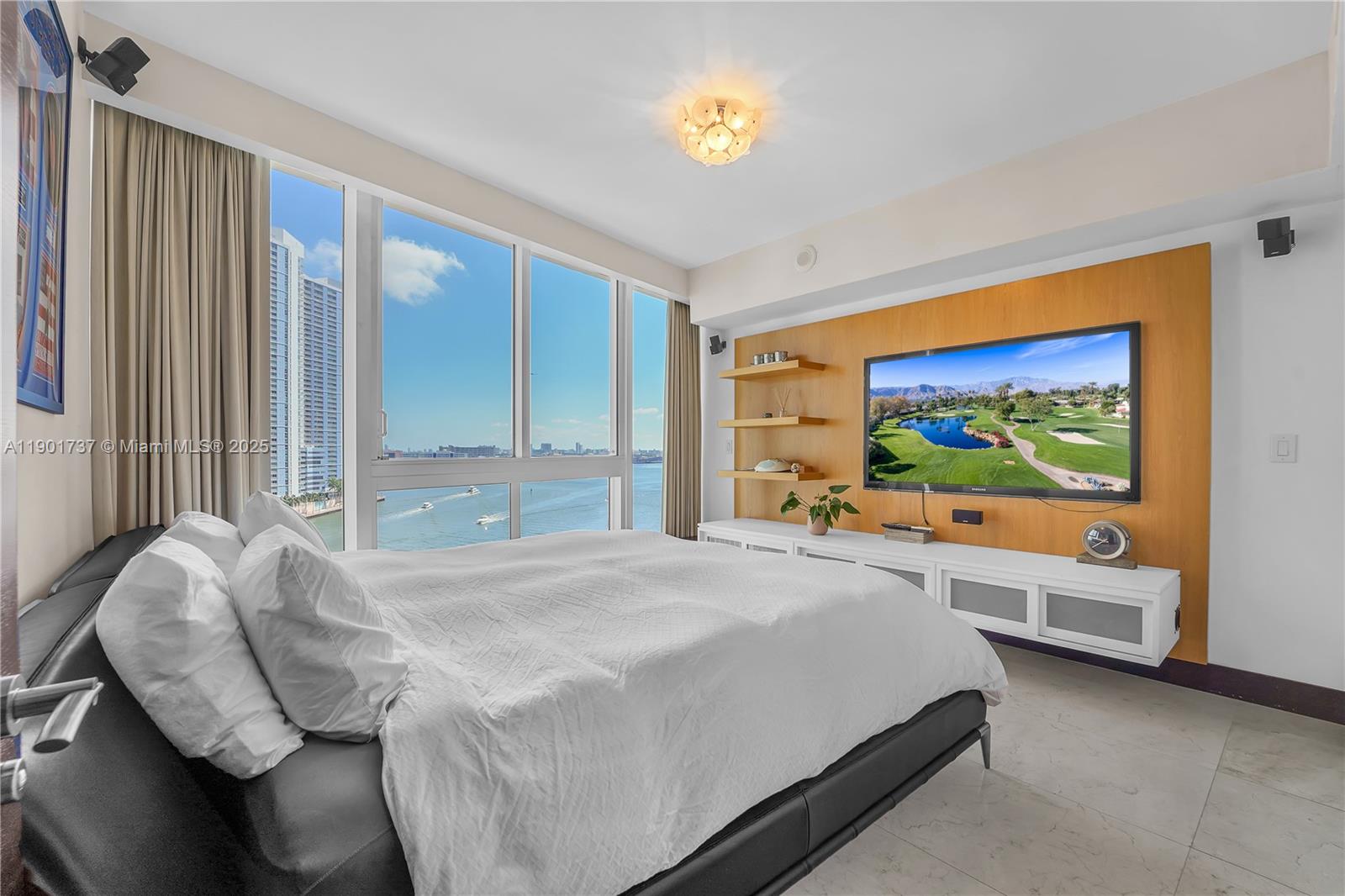 465 Brickell Avenue, Unit 1001 Miami, FL 33131 - Photo 28 of 42 a bedroom with a bed and a large window