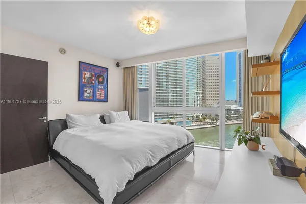 a bedroom with a bed and a couch