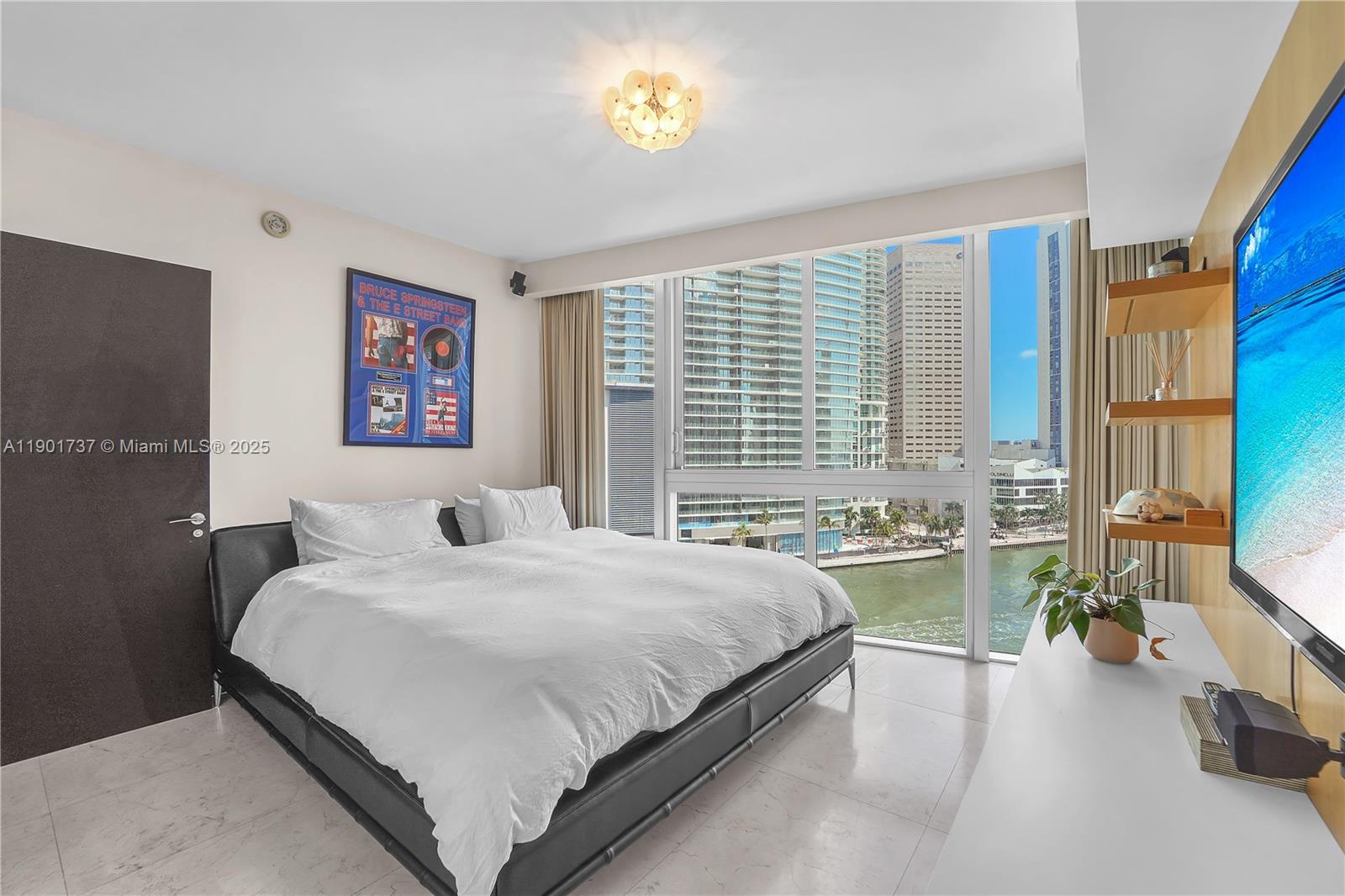 465 Brickell Avenue, Unit 1001 Miami, FL 33131 - Photo 29 of 42 a bedroom with a bed and a couch
