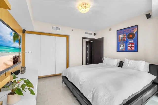 a bedroom with a bed and a chandelier