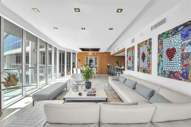 a living room with furniture and large windows