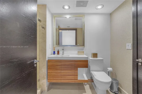 a bathroom with a toilet sink and mirror
