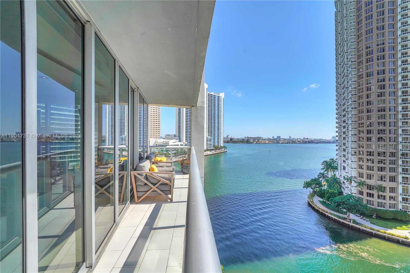 465 Brickell Avenue, Unit 1001 Miami, FL 33131 - Photo 42 of 42 a balcony with chairs and wooden floor