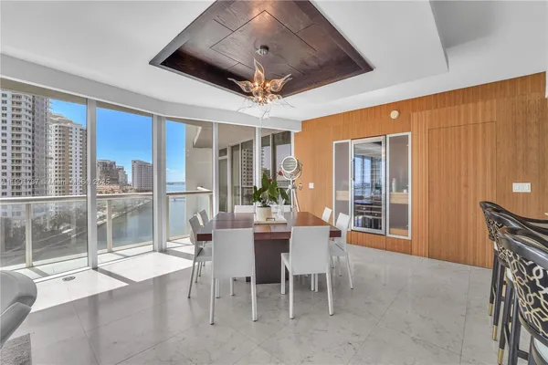 a dining room with stainless steel appliances granite countertop furniture and a fireplace