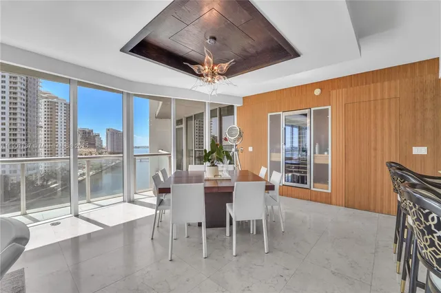 a dining room with stainless steel appliances granite countertop furniture and a fireplace