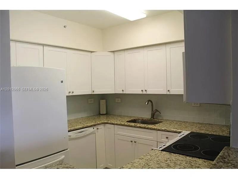 1500 Bay Road, Unit 318S Miami Beach, FL 33139 - Photo 3 of 6 a kitchen with a sink and cabinets