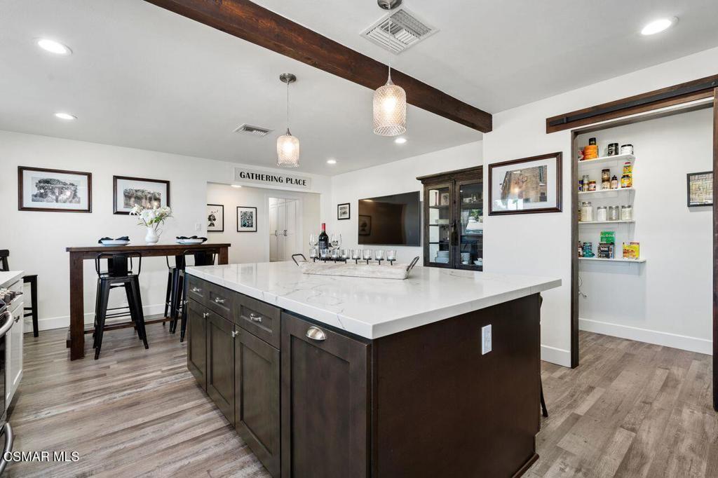 1135 Donner Avenue Simi Valley, CA 93065 - Photo 11 of 48 a kitchen with stainless steel appliances kitchen island granite countertop a sink and cabinets