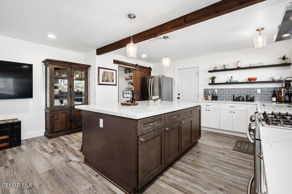 1135 Donner Avenue Simi Valley, CA 93065 - Photo 12 of 48 a kitchen with stainless steel appliances granite countertop a large counter top space and cabinets