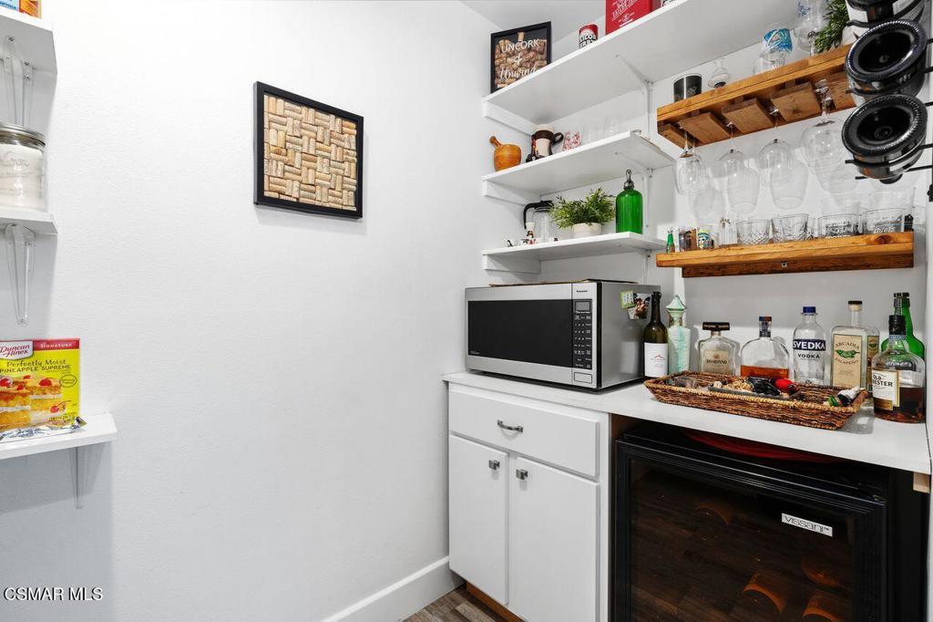 1135 Donner Avenue Simi Valley, CA 93065 - Photo 13 of 48 a kitchen with stainless steel appliances a microwave a stove and cabinets