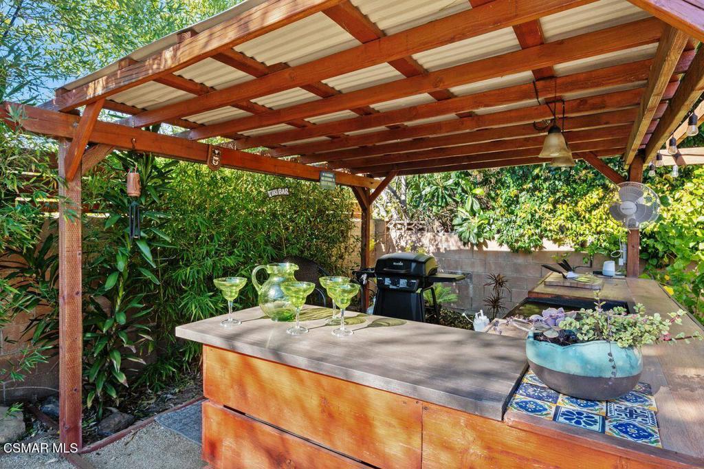 1135 Donner Avenue Simi Valley, CA 93065 - Photo 39 of 48 a view of patio with a table and chairs under an umbrella