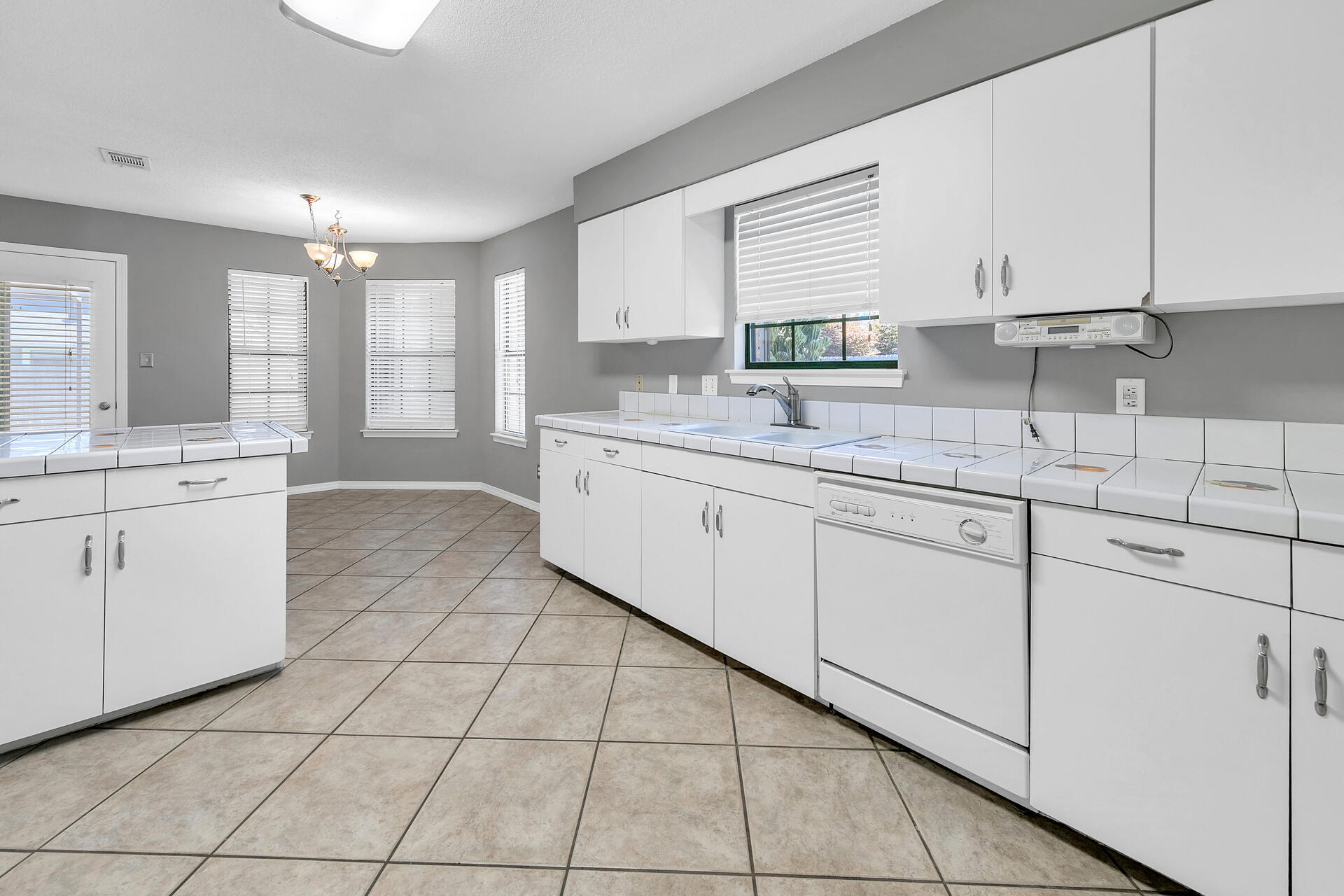 326 Sailfish Circle Destin, FL 32541 - Photo 12 of 28 a kitchen with a sink window and cabinets