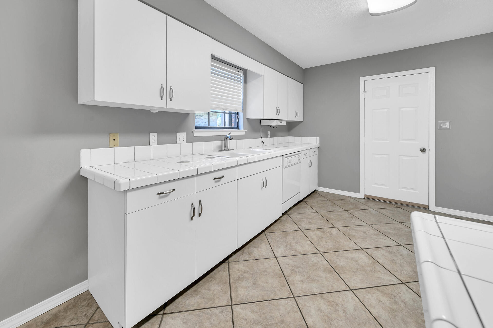 326 Sailfish Circle Destin, FL 32541 - Photo 13 of 28 a kitchen with stainless steel appliances granite countertop a sink and a white cabinets