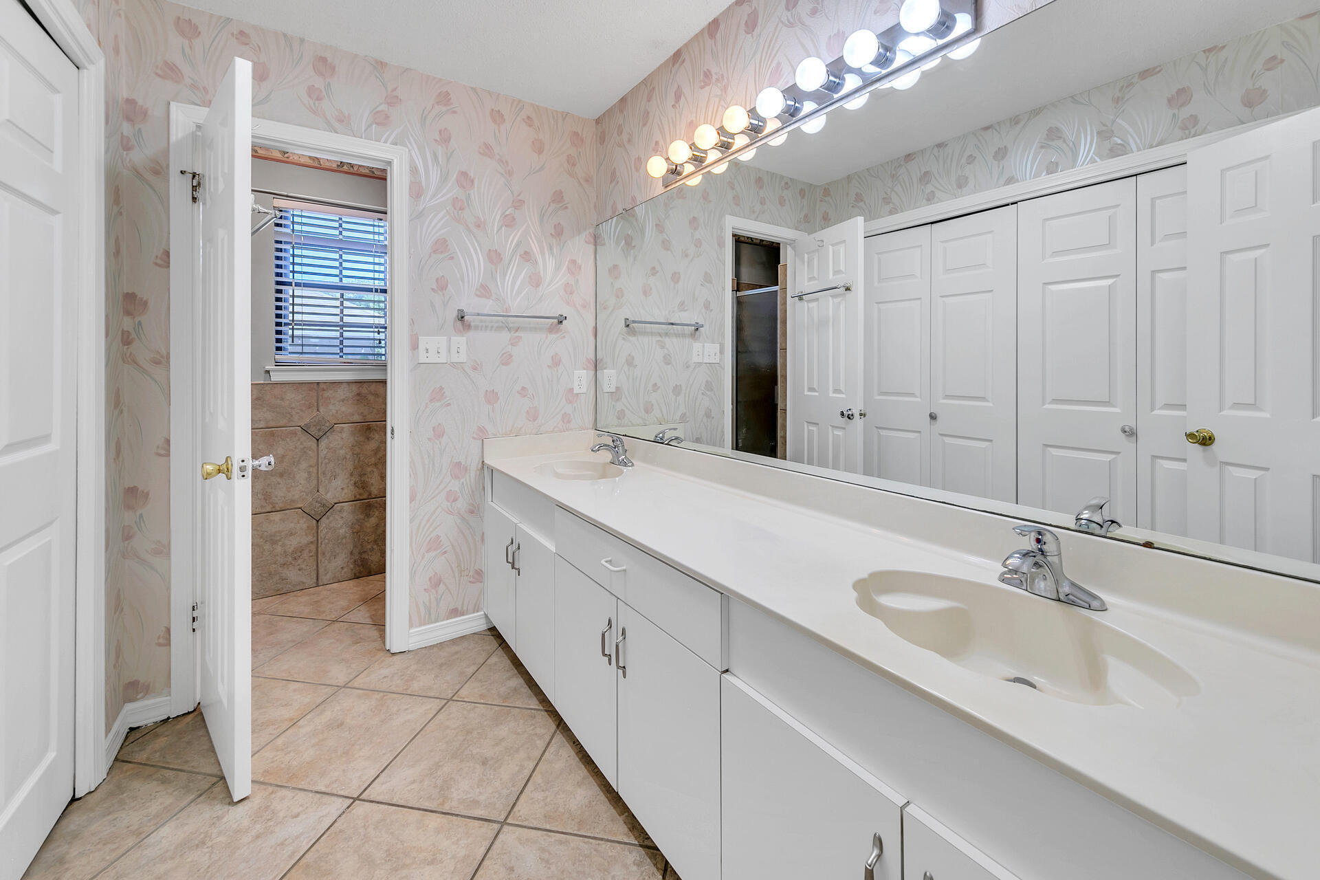 326 Sailfish Circle Destin, FL 32541 - Photo 17 of 28 a spacious bathroom with a double vanity sink a mirror and a shower