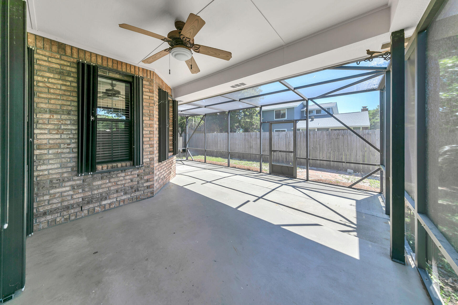 326 Sailfish Circle Destin, FL 32541 - Photo 26 of 28 a view of an empty room with a fireplace and windows