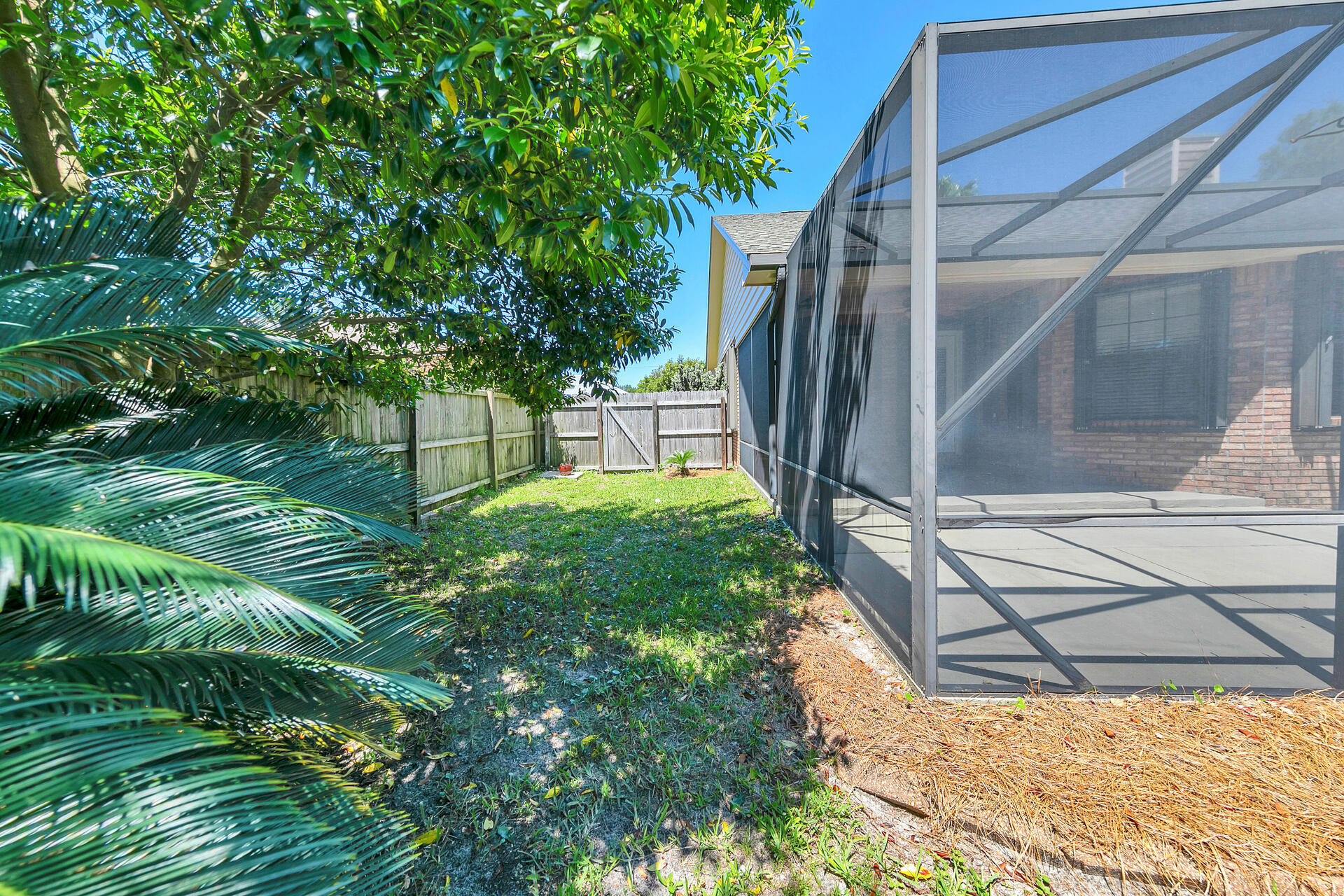 326 Sailfish Circle Destin, FL 32541 - Photo 28 of 28 a backyard of a house with lots of green space