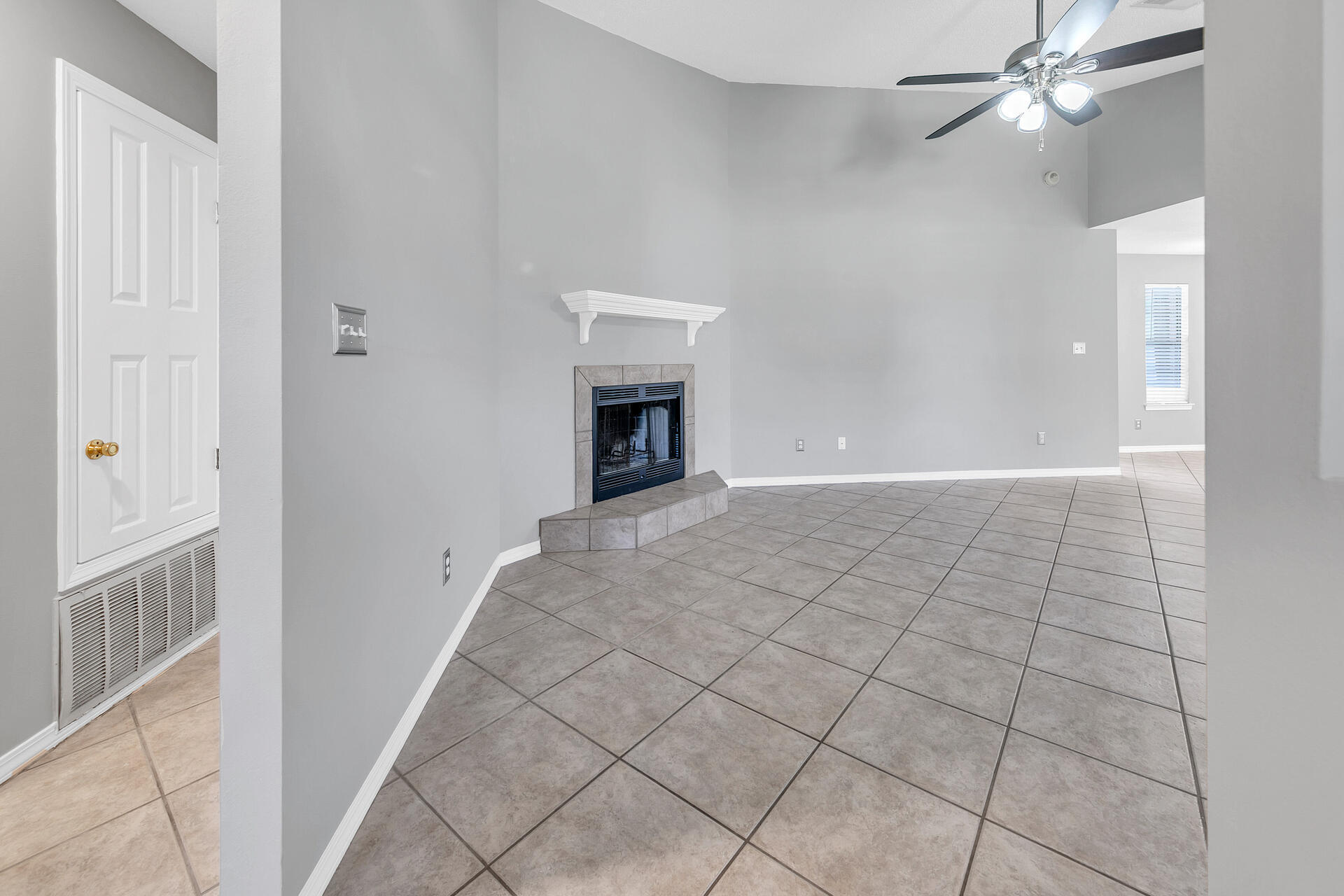 326 Sailfish Circle Destin, FL 32541 - Photo 5 of 28 a view of an empty room with chandelier fan and fire place