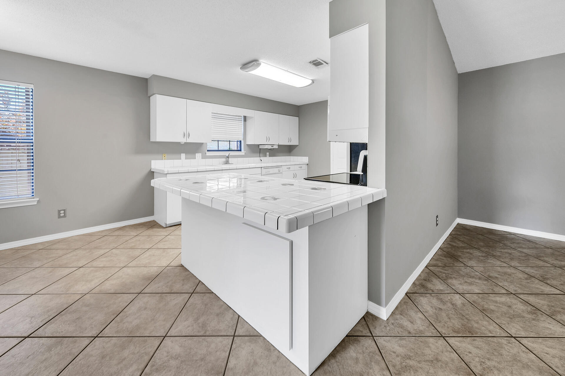 326 Sailfish Circle Destin, FL 32541 - Photo 9 of 28 a kitchen with a sink stove and cabinets