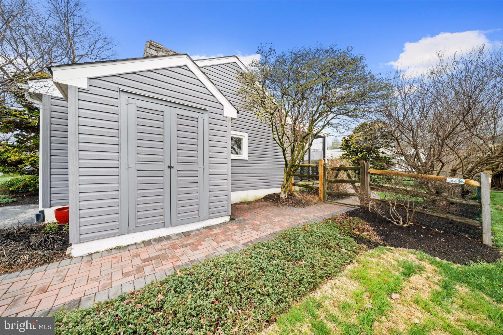 47 Paschall Road Wilmington, DE 19803 - Photo 17 of 26 Charming garden shed by a pathway.