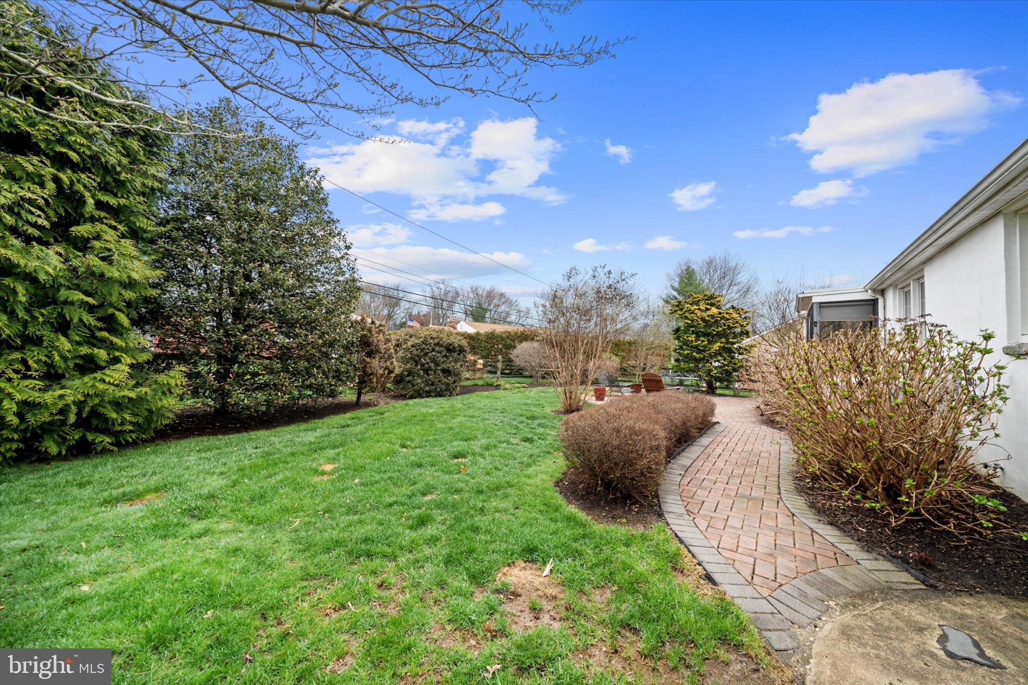 47 Paschall Road Wilmington, DE 19803 - Photo 22 of 26 Serene garden path under blue skies.
