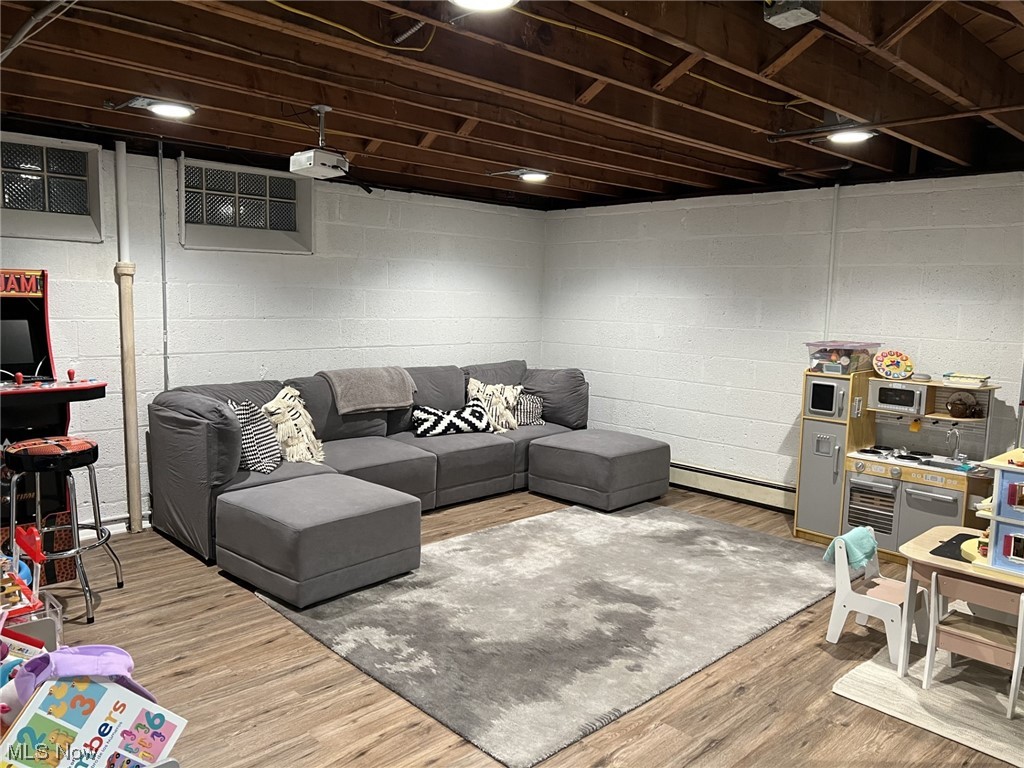 1318 Sunset Road Cleveland, OH 44124 - Photo 24 of 29 Recreation room with light wood-style floors can serve a multitude of purposes for your enjoyment!