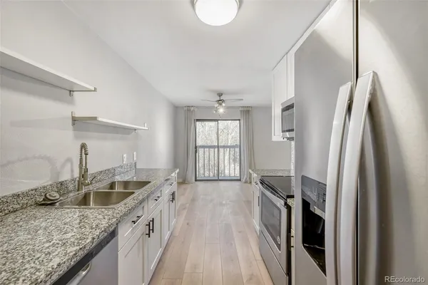 a kitchen with a sink stove and refrigerator
