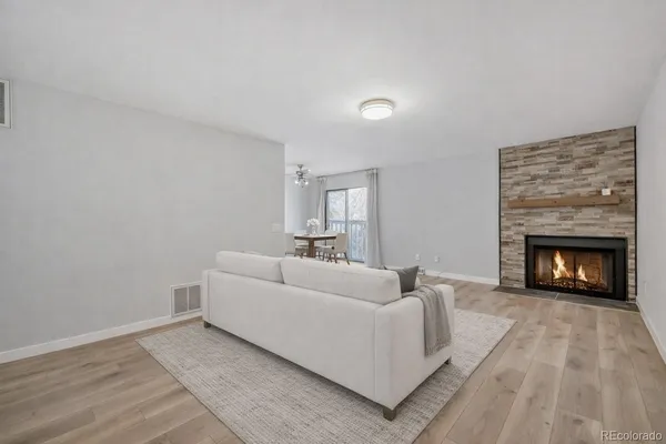 a living room with furniture and a fireplace