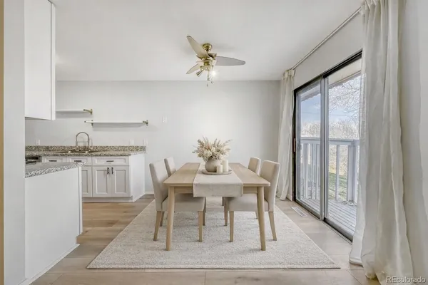 a dining room with wooden floor and a rug