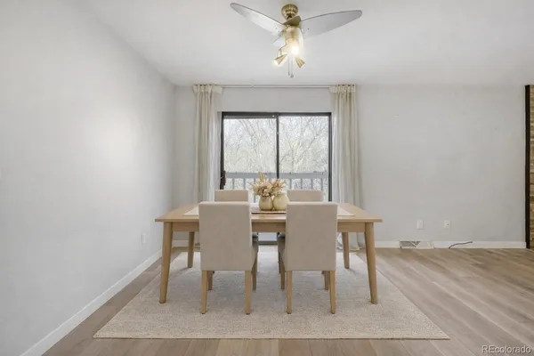 a view of a dining room with furniture window and wooden floor