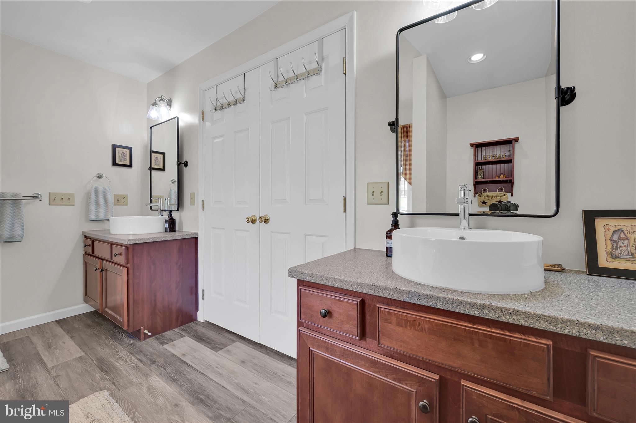 111 Holly Road Orwigsburg, PA 17961 - Photo 27 of 46 a bathroom with a granite countertop sink a mirror and shower