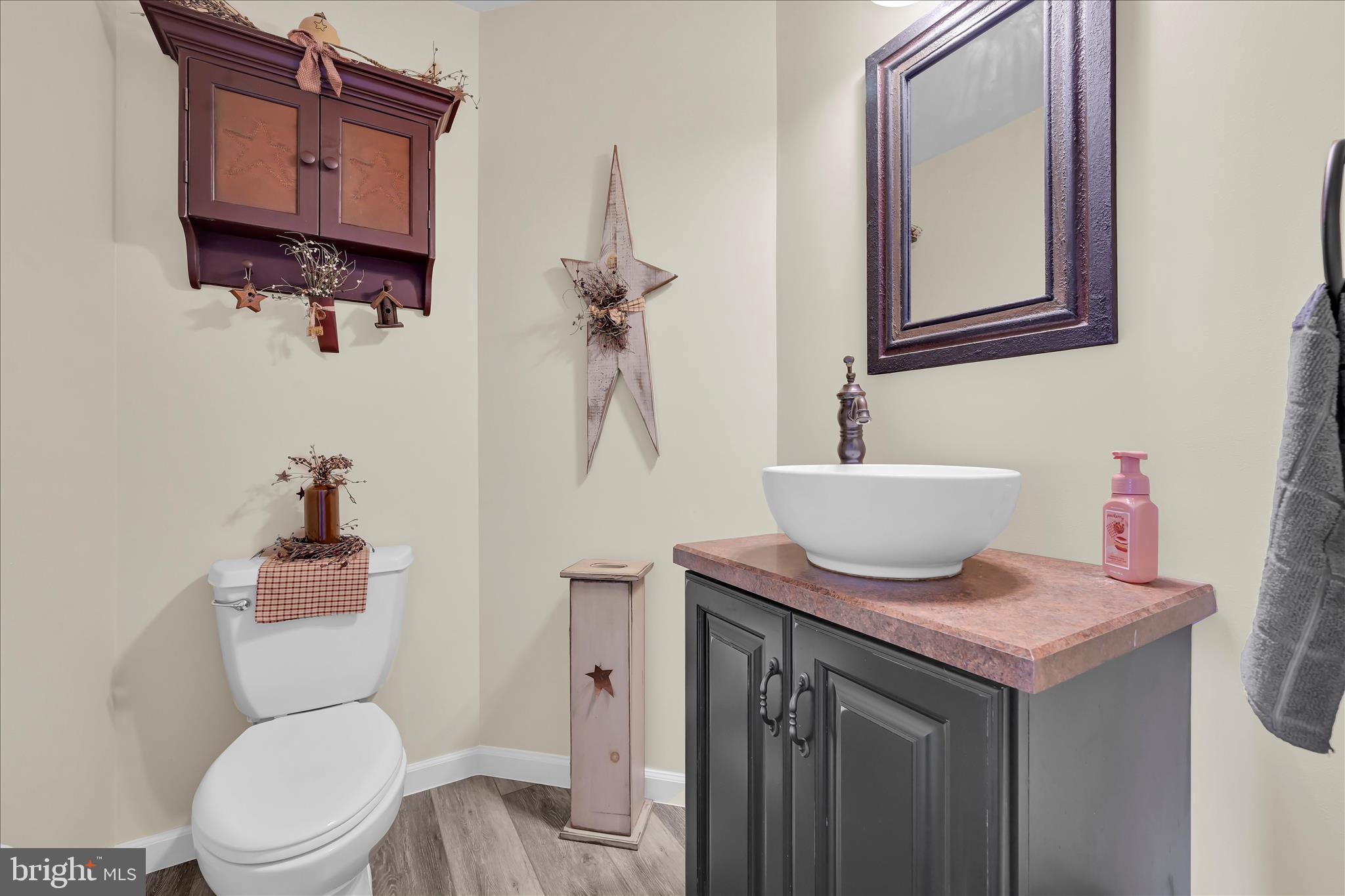 111 Holly Road Orwigsburg, PA 17961 - Photo 40 of 46 a bathroom with a toilet a sink and mirror