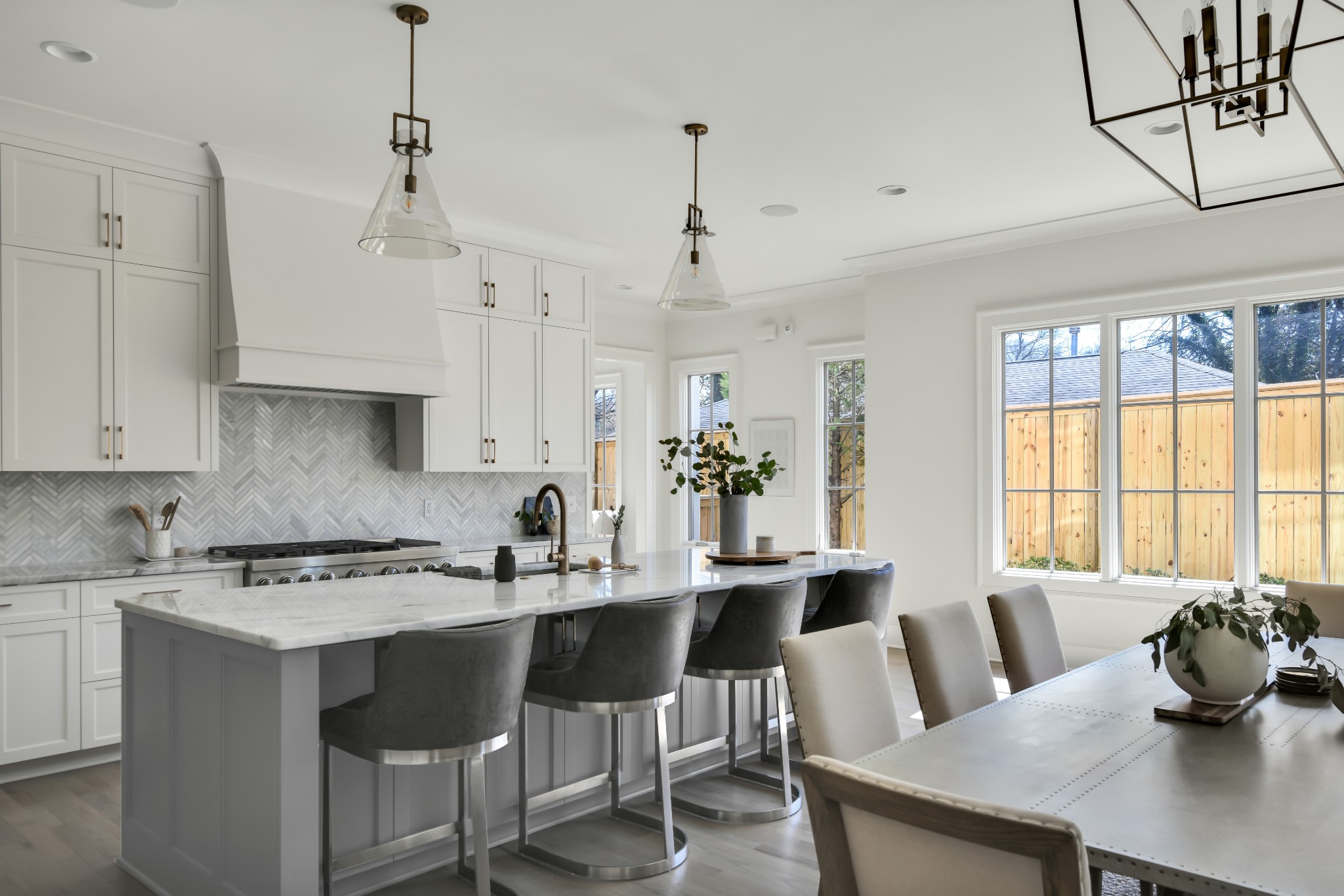 211B Page Road Nashville, TN 37205 - Photo 7 of 43 a kitchen with stainless steel appliances kitchen island granite countertop a dining table chairs and white cabinets