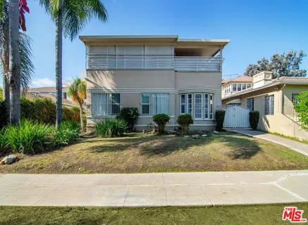 a view of a house with a yard and plants