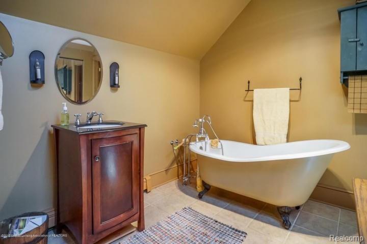 5301 Sherwood Road Webberville, MI 48892 - Photo 27 of 30 Master bathroom with claw foot tub, lots of closet space and dressing room space!