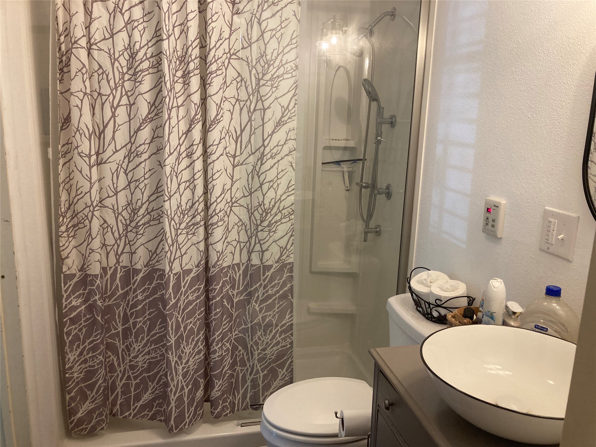 142 Walnut Ridge Livingston, TX 77351 - Photo 13 of 36 Cozy bathroom with a modern vessel sink, toilet, and shower-tub combo. Features a decorative shower curtain and ample countertop space for essentials.