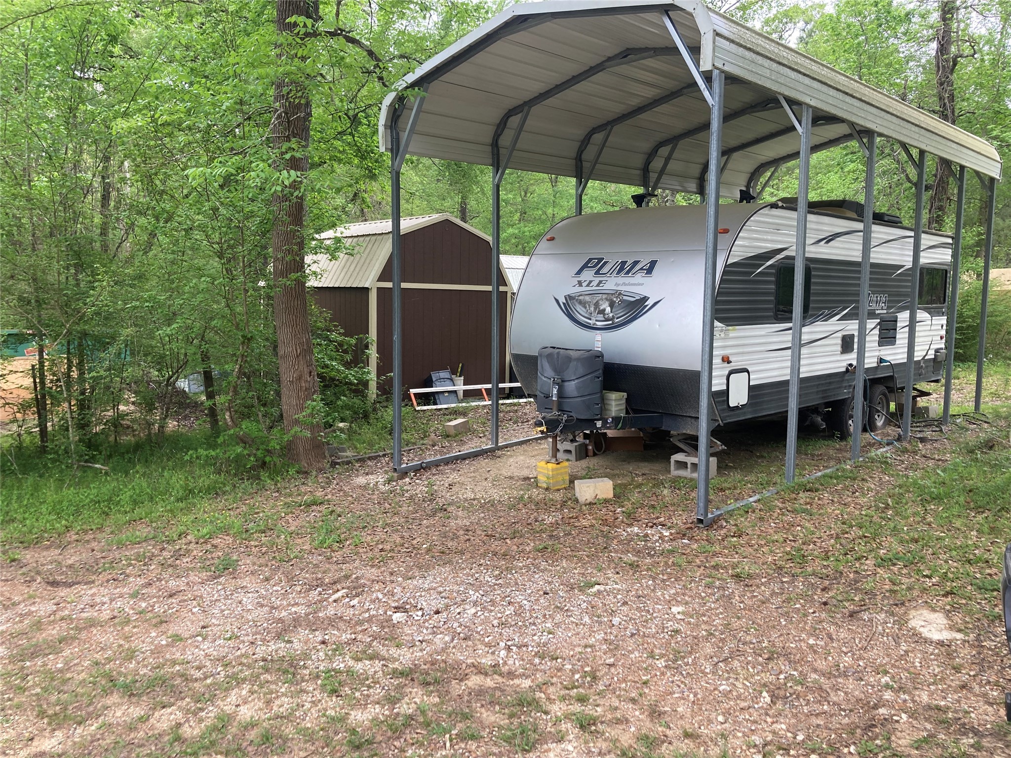 142 Walnut Ridge Livingston, TX 77351 - Photo 20 of 36 RV parking with protective cover—ideal for adventurers and road travelers.