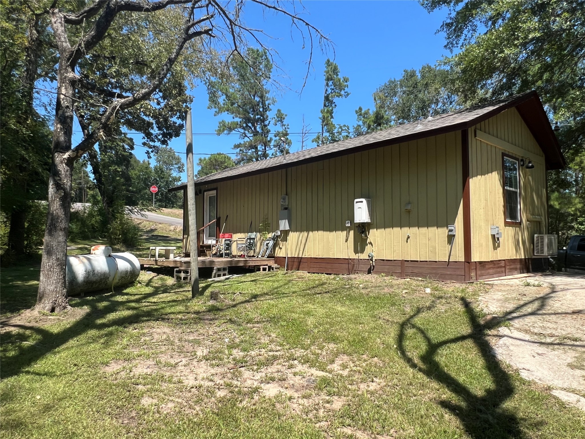 142 Walnut Ridge Livingston, TX 77351 - Photo 35 of 36 Back of the house with propane tank and tankless water heater