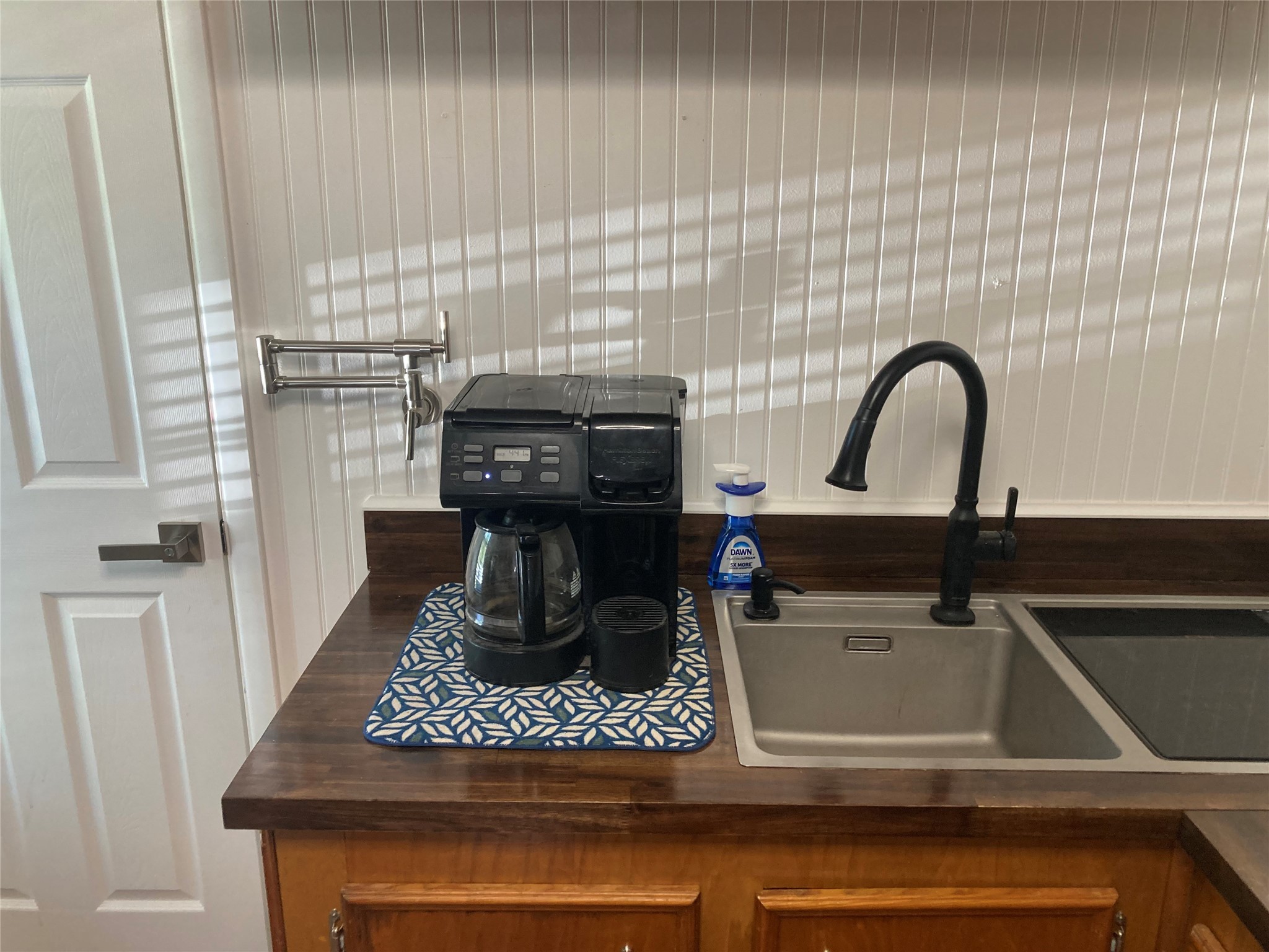 142 Walnut Ridge Livingston, TX 77351 - Photo 6 of 36 Start your mornings right in this inviting kitchen corner, complete with a sleek coffee maker beside a modern sink, perfect for preparing your daily brew.