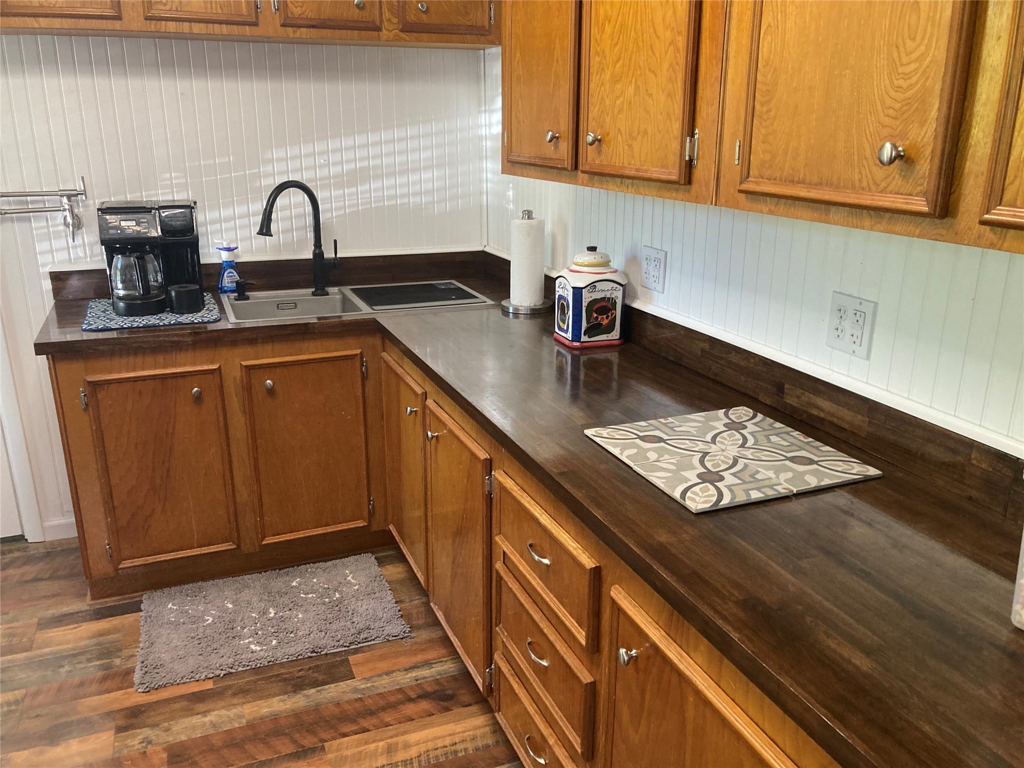 142 Walnut Ridge Livingston, TX 77351 - Photo 8 of 36 Elegant wooden countertops complement the warm cabinetry, creating a charming and functional kitchen space.