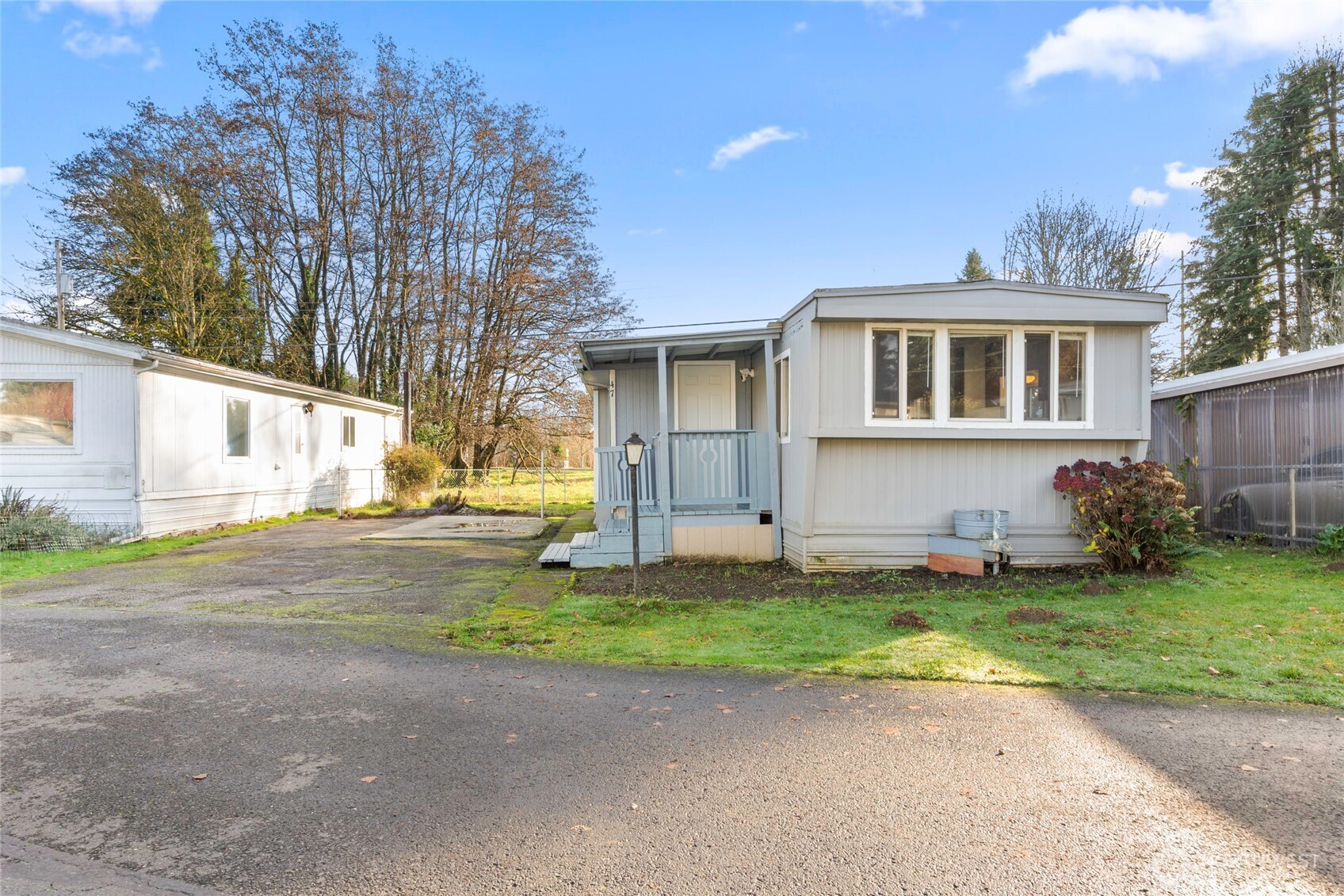 1617 Fones Road Southeast, Unit 47 Olympia, WA 98501 - Photo 12 of 15 a front view of a house with a yard and garage