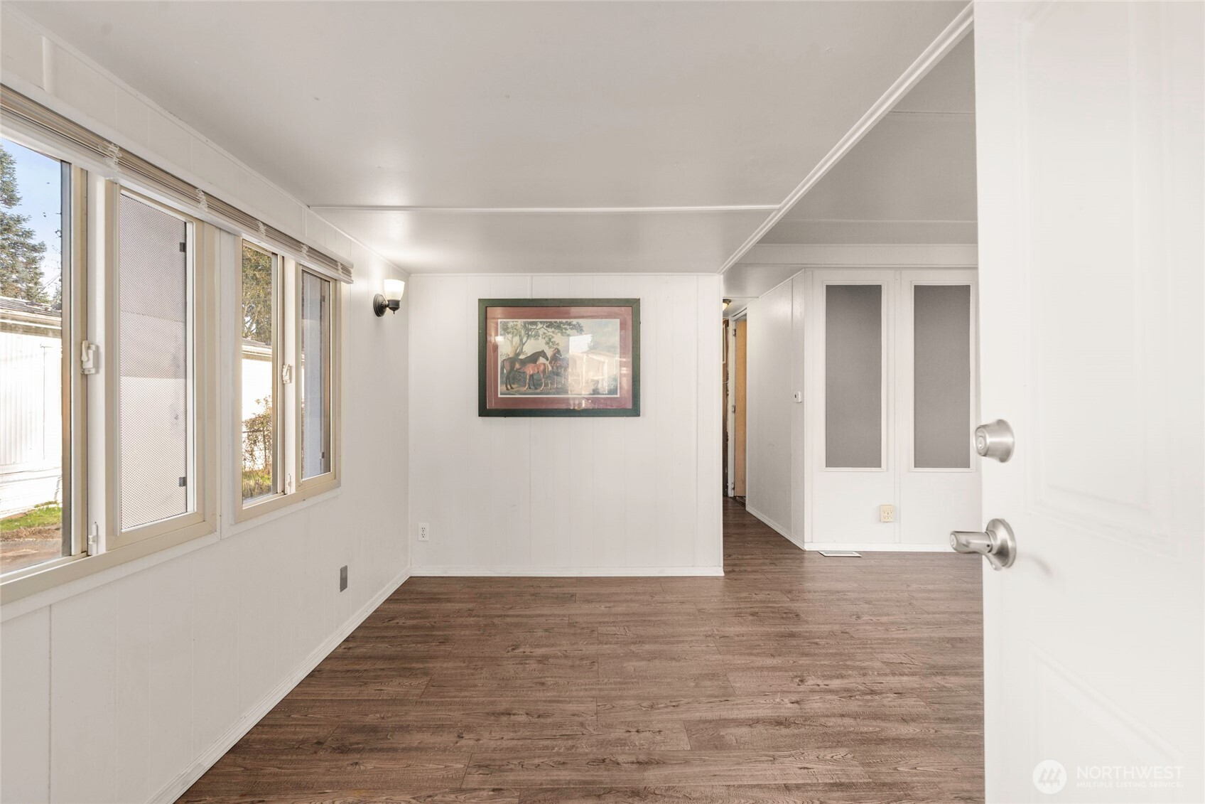 1617 Fones Road Southeast, Unit 47 Olympia, WA 98501 - Photo 3 of 15 a view of an empty room with wooden floor and a window