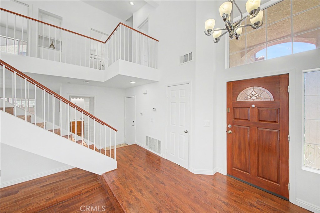 15377 Tobarra Road Fontana, CA 92337 - Photo 7 of 38 Beautiful laminate wood flooring and custom tile throughout