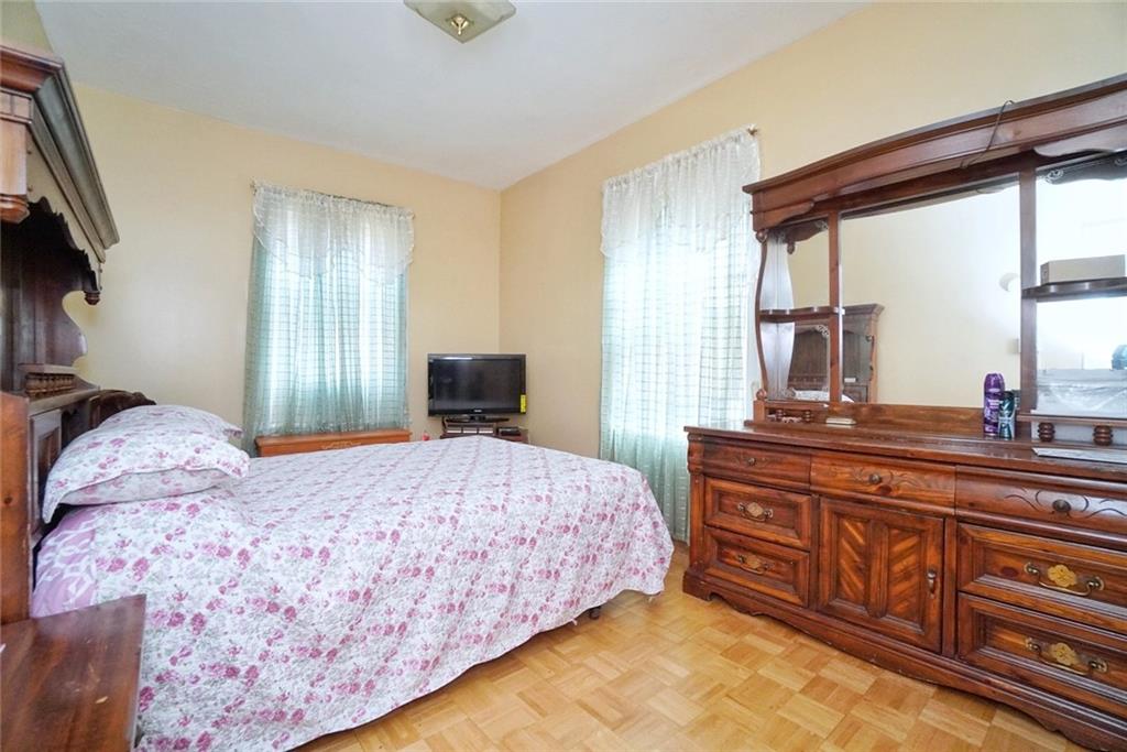 157 Sullivan Place Brooklyn, NY 11225 - Photo 6 of 28 a bedroom with a bed and a dresser with mirror