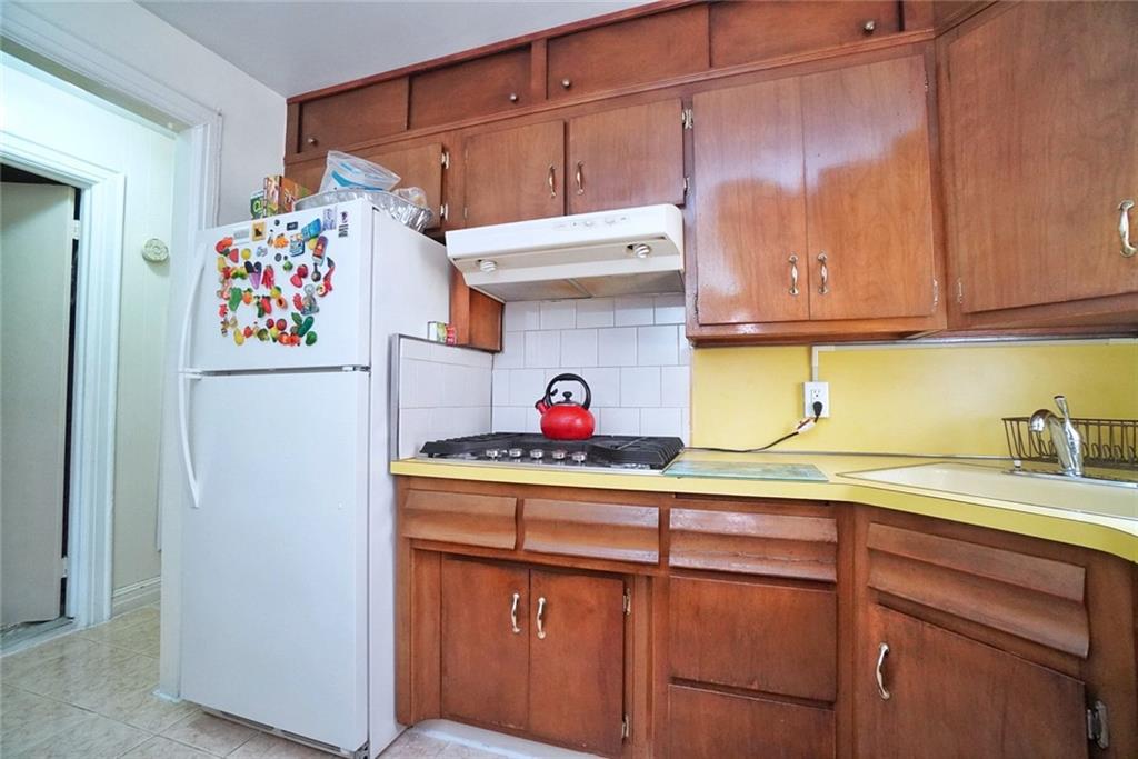 157 Sullivan Place Brooklyn, NY 11225 - Photo 9 of 28 a kitchen with stainless steel appliances granite countertop a refrigerator and a sink