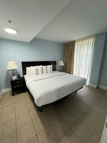 a bedroom with a bed and a lamp on table