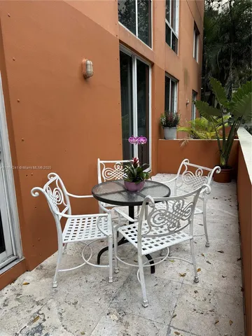 a view of a patio with table and chairs and potted plants