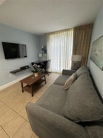 a kitchen with a sink a stove and cabinets
